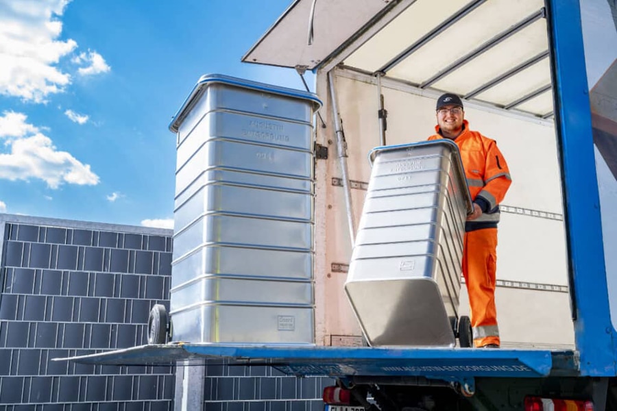 Mitarbeiter beim Verladen von Behältern zur Aktenvernichtung